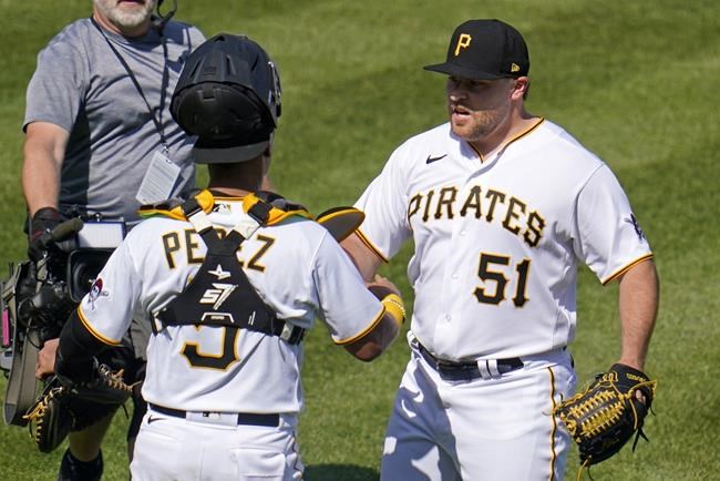 Pittsburgh Pirates relief pitcher David Bednar (51) celebrates with catcher Michael Perez after getting the final out of a baseball game against the Cincinnati Reds in Pittsburgh, Sunday, May 15, 2022. (AP Photo/Gene J. Puskar)