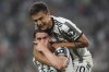 Juventus's Dusan Vlaovic celebrates scoring with teammate Paulo Dybala, top, during the Serie A soccer match between Juventus and Lazio at Allianz Stadium, Turin, Italy, Monday May 16, 2022. (Spada/LaPresse via AP)