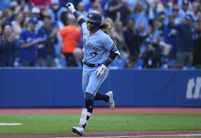 Toronto Blue Jays shortstop Bo Bichette (11) rounds the bases after hitting a solo home run against the Seattle Mariners during first inning American League, MLB baseball action in Toronto on Monday, May 16, 2022. THE CANADIAN PRESS/Nathan Denette