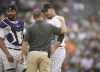 Colorado Rockies assistant trainer Heath Townsend, center, confers with starting pitcher Antonio Senzatela, right, as catcher Elias Diaz looks on before the third inning of a baseball game against the San Francisco Giants, Monday, May 16, 2022, in Denver. Senzatela left the game and was replaced by relief pitcher Ty Blach. (AP Photo/David Zalubowski)