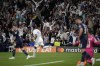 Real Madrid's fans celebrate the fist goal of their team during the Champions League semi final, second leg, soccer match between Real Madrid and Manchester City at the Santiago Bernabeu stadium in Madrid, Spain, Wednesday, May 4, 2022. (AP Photo/Bernat Armangue)