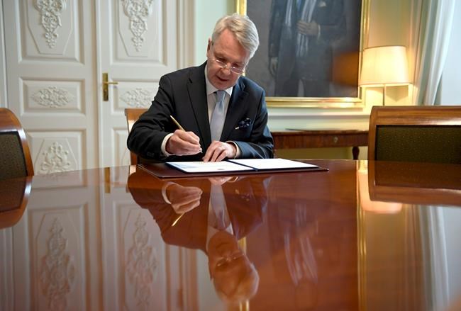 Finnish Foreign Minister Pekka Haavisto signs a petition for NATO membership application in Helsinki, Tuesday, May 17, 2022. Sweden and Finland on Tuesday pushed ahead with their bids to join NATO even as Turkey insisted it won’t let the previously non-aligned Nordic countries into the alliance because of their alleged support for Kurdish militants. (Annti Aimo-Koivisto/Lehtikuva via AP)