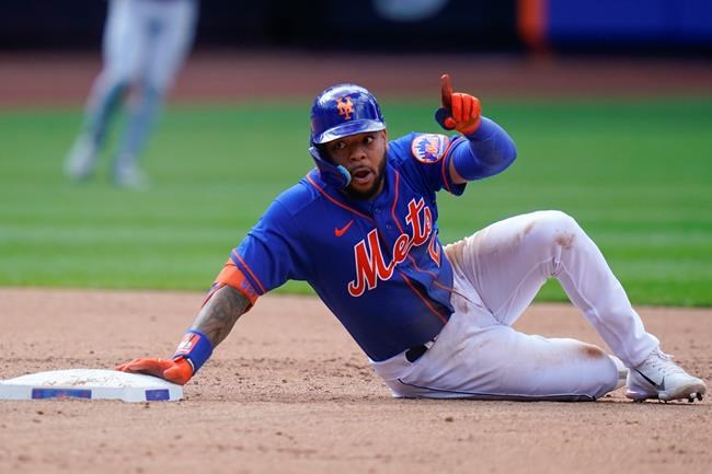 New York Mets' Dominic Smith gestures after hitting an RBI double during the third inning in the first baseball game of a doubleheader against the St. Louis Cardinals Tuesday, May 17, 2022, in New York. (AP Photo/Frank Franklin II)