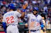 Chicago Cubs' Jonathan Villar (24) and Jason Heyward (22) celebrate their runs scored against the Arizona Diamondbacks during the third inning of a baseball game Friday, May 13, 2022, in Phoenix. (AP Photo/Ross D. Franklin)