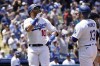 Los Angeles Dodgers' Justin Turner, left, celebrates his two-run home run with Max Muncy (13) during the sixth inning of the first game of a baseball double-header against the Arizona Diamondbacks Tuesday, May 17, 2022, in Los Angeles. (AP Photo/Marcio Jose Sanchez)