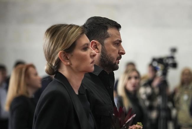 President of Ukraine Volodymyr Zelenskyy and and his wife Olena Zelenska attend the farewell ceremony of Leonid Kravchuk, independent Ukraine's first president, at the International Convention Center Ukrainian House, in Kyiv, Ukraine, Tuesday, May 17, 2022. Kravchuk led Ukraine to independence amid the collapse of the Soviet Union and served as its first president. He died on May 10 at the age of 88. (AP Photo/Evgeniy Maloletka)