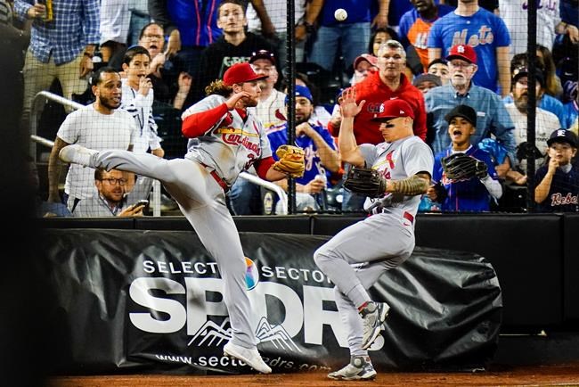 St. Louis Cardinals' Brendan Donovan, left, and Tyler O'Neill, right, run into each other while trying to catch a foul ball hit by New York Mets' Francisco Lindor during the eighth inning in the second baseball game of a doubleheader Tuesday, May 17, 2022, in New York. (AP Photo/Frank Franklin II)
