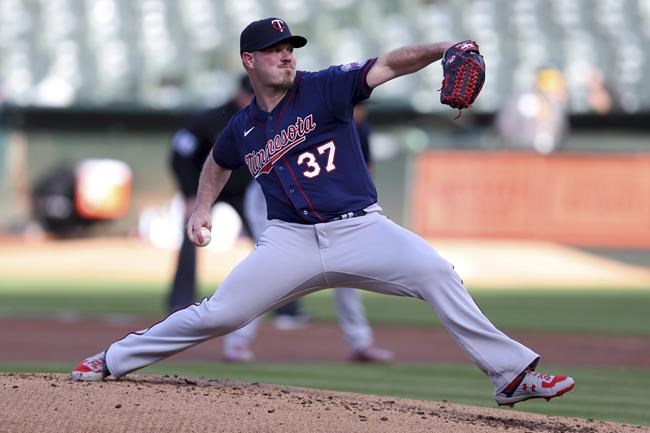 Minnesota Twins' Dylan Bundy pitches against the Oakland Athletics during the first inning of a baseball game in Oakland, Calif., Tuesday, May 17, 2022. (AP Photo/Jed Jacobsohn)