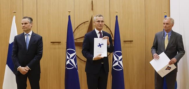Finland's Ambassador to NATO Klaus Korhonen, NATO Secretary-General Jens Stoltenberg and Sweden's Ambassador to NATO Axel Wernhoff attend a ceremony to mark Sweden's and Finland's application for membership in Brussels, Belgium, Wednesday May 18, 2022. NATO Secretary-General Jens Stoltenberg said that the military alliance stands ready to seize a historic moment and move quickly on allowing Finland and Sweden to join its ranks, after the two countries submitted their membership requests. (Johanna Geron/Pool via AP)