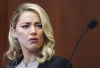 Amber Heard reacts in the courtroom at the Fairfax County Circuit Courthouse in Fairfax, Va., Wednesday, May 18, 2022. Actor Johnny Depp sued his ex-wife Amber Heard for libel in Fairfax County Circuit Court after she wrote an op-ed piece in The Washington Post in 2018 referring to herself as a 