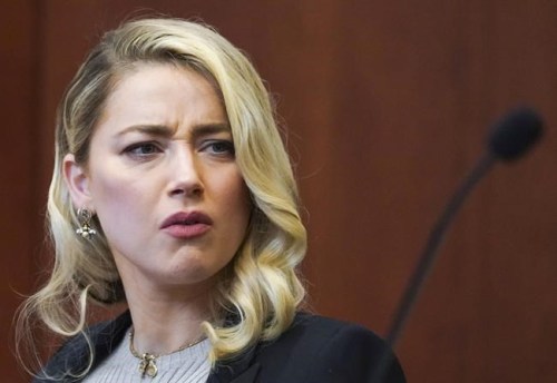 Amber Heard reacts in the courtroom at the Fairfax County Circuit Courthouse in Fairfax, Va., Wednesday, May 18, 2022. Actor Johnny Depp sued his ex-wife Amber Heard for libel in Fairfax County Circuit Court after she wrote an op-ed piece in The Washington Post in 2018 referring to herself as a 