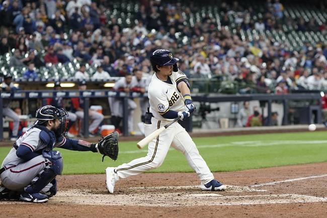 Milwaukee Brewers' Keston Hiura hits a walkoff two-run home run during the 11th inning of a baseball game against the Atlanta Braves Wednesday, May 18, 2022, in Milwaukee. The Brewers won 7-6. (AP Photo/Morry Gash)