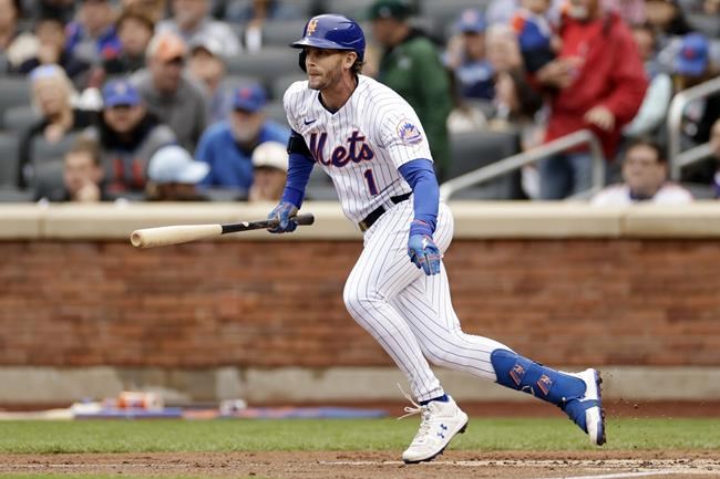 New York Mets' Jeff McNeil hits a run scoring fielder's choice during the first inning of a baseball game against the St. Louis Cardinals on Thursday, May 19, 2022, in New York. (AP Photo/Adam Hunger)