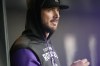 Colorado Rockies left fielder Kris Bryant, who was put on the injured list, watches from the dugout during the first inning of the team's baseball game against the Cincinnati Reds on Friday, April 29, 2022, in Denver. (AP Photo/David Zalubowski)