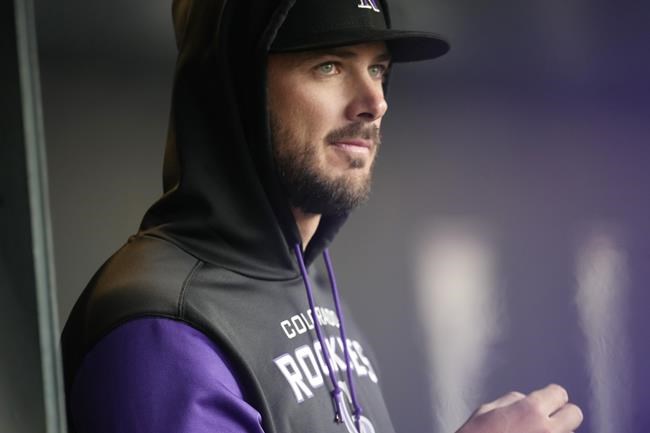 Colorado Rockies left fielder Kris Bryant, who was put on the injured list, watches from the dugout during the first inning of the team's baseball game against the Cincinnati Reds on Friday, April 29, 2022, in Denver. (AP Photo/David Zalubowski)