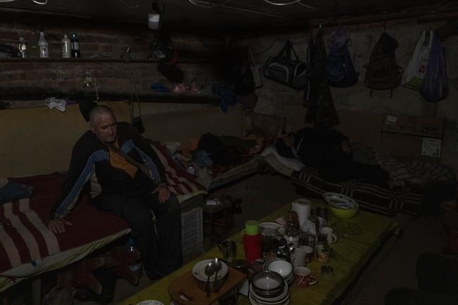 Residents live in the basement of a building used as bomb shelter in the village of Staryi Saltiv, east Kharkiv, Ukraine, Friday, May 20, 2022. The village formerly occupied by Russian forces is back under Ukrainian control, albeit very close to the front line and under constant shelling. (AP Photo/Bernat Armangue)
