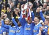 Rangers' James Tavernier lifts the Scottish Cup after the final whistle of the Scottish Cup soccer final between Heart of Midlothian FC and Rangers at Hampden Park, Glasgow, Scotland, Saturday, May 21, 2022. (Steve Welsh/PA via AP)