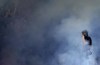 Atalanta fans burn smoke flares ahead of a Serie A soccer match between Atalanta and Empoli, in Bergamo's Gewiss stadium, Italy, Saturday, May 21, 2022. (Spada/LaPresse via AP)