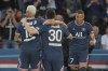 PSG's Kylian Mbappe, right, gestures as he celebrates after he second goal during French League One soccer match between Paris Saint Germain and Metz at the Parc des Princes stadium in Paris, France, Saturday, May 21, 2022. (AP Photo/Michel Spingler)
