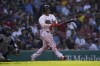 Boston Red Sox's Rafael Devers, right, watches his home run in the third inning in a baseball game against the Seattle Mariners, Saturday, May 21, 2022, in Boston. (AP Photo/Robert F. Bukaty)