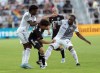D.C. United midfielder Sofiane Djeffal (13) battles for the ball with Toronto FC forward Ayo Akinola (20) and forward Deandre Kerr, left, during the first half of an MLS soccer match in Washington, Saturday, May 21, 2022. (AP Photo/Manuel Balce Ceneta)