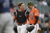 Baltimore Orioles catcher Adley Rutschman, left, talks with pitcher Kyle Bradish after the top of the second inning of the team's baseball game against the Tampa Bay Rays on Saturday, May 21, 2022, in Baltimore. (AP Photo/Gail Burton)