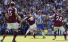 West Ham United's Declan Rice, left, and Brighton and Hove Albion's Pascal Gross battle for the ball during their English Premier League match at The AMEX Stadium, Brighton, England, Sunday, May 22, 2022. (Gareth Fuller/PA via AP)