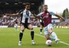 Newcastle United's Jacob Murphy, left, and Burnley's Charlie Taylor battle for the ball during their English Premier League soccer match at Turf Moor, Burnley, England, Sunday, May 22, 2022. (Nick Potts/PA via AP)