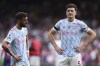 Manchester United's Harry Maguire, right, and Bruno Fernandes react after their loss in the English Premier League soccer match against Crystal Palace at Selhurst Park stadium in London, Sunday, May 22, 2022. (AP Photo/Ian Walton)