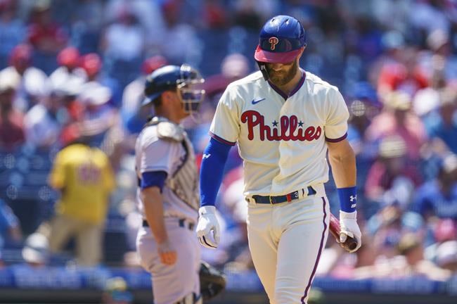 Philadelphia Phillies' Bryce Harper looks down after striking out during the fourth inning of a baseball game against the Los Angeles Dodgers, Sunday, May 22, 2022, in Philadelphia. (AP Photo/Chris Szagola)