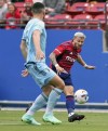 FC Dallas' Paul Arriola, right, attempts a shot on goal against Minnesota United defender Michael Boxall during the first half of an MLS soccer match, Sunday, May 22, 2022, in Frisco, Texas. (Steve Nurenberg/The Dallas Morning News via AP)