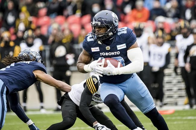Toronto Argonauts linebacker Henoc Muamba (10) runs with the ball against the Hamilton Tiger-Cats, during first half CFL Eastern Conference final action in Toronto, on Sunday, December 5, 2021. THE CANADIAN PRESS/Christopher Katsarov
