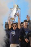 Manchester City's Jack Grealish lifts the trophy on stage as fans watch the winners parade as the team celebrates winning the English Premier League title in Manchester, England, Monday, May 23, 2022. (AP Photo/Jon Super)