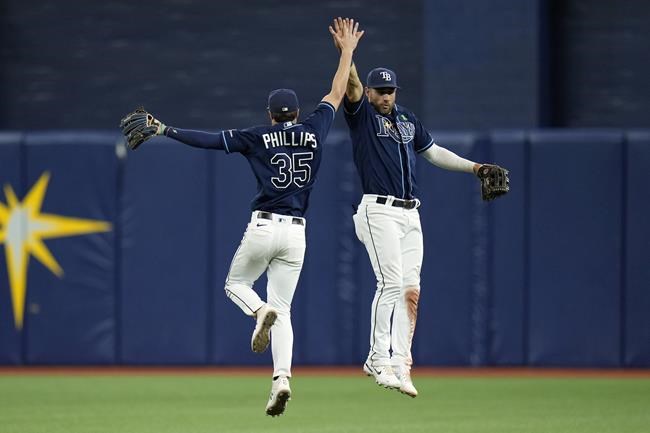 Tampa Bay Rays right fielder Brett Phillips (35) and center fielder Kevin Kiermaier celebrate after the team defeated the Miami Marlins during a baseball game Tuesday, May 24, 2022, in St. Petersburg, Fla. (AP Photo/Chris O'Meara)