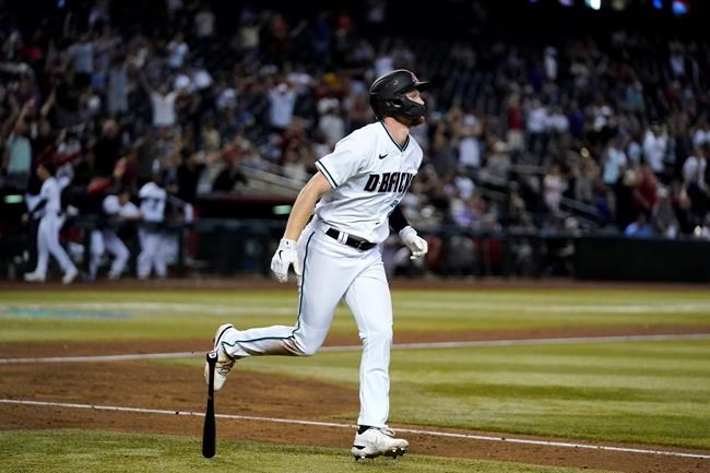 Arizona Diamondbacks' Pavin Smith watches his home run against the Kansas City Royals during the sixth inning of a baseball game Tuesday, May 24, 2022, in Phoenix. (AP Photo/Ross D. Franklin)