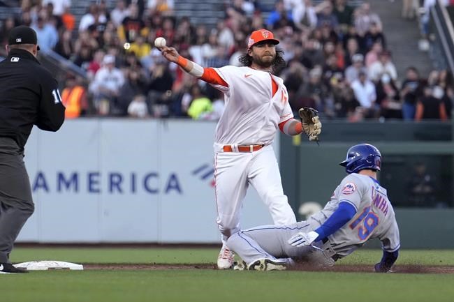 San Francisco Giants shortstop Brandon Crawford throws to first base after forcing out New York Mets' Mark Canha (19) during during the second inning of a baseball game in San Francisco, Tuesday, May 24, 2022. Dominic Smith was safe at first. (AP Photo/Tony Avelar)