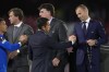 UEFA President Aleksander Ceferin, right, hands a second place medal to Rangers' head coach Giovanni van Bronckhorst after the Europa League final soccer match between Eintracht Frankfurt and Rangers FC at the Ramon Sanchez Pizjuan stadium in Seville, Spain, Wednesday, May 18, 2022. Frankfurt defeated Rangers 5-4 in a penalty shootout after the game ended tied 1-1. (AP Photo/Manu Fernandez)