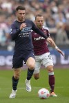 Manchester City's Aymeric Laporte, left, West Ham's Vladimir Coufal fight for the ball during the English Premier League soccer match between West Ham United and Manchester City at London stadium in London, Sunday, May 15, 2022. (AP Photo/Kirsty Wigglesworth)