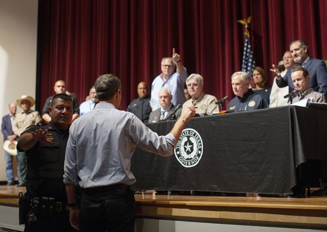 Democrat Beto O'Rourke, who is running against Greg Abbott for governor in 2022, interrupts a news conference headed by Texas Gov. Greg Abbott in Uvalde, Texas Wednesday, May 25, 2022. (AP Photo/Dario Lopez-Mills)