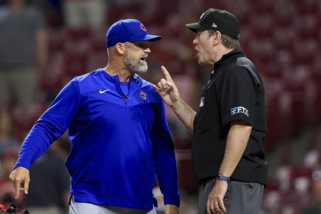 Chicago Cubs' David Ross, left, argues with umpire Chris Conroy, after being ejected by Dan Merzel during the ninth inning of the team's baseball game against the Cincinnati Reds in Cincinnati, Wednesday, May 25, 2022. The Reds won 4-3. (AP Photo/Aaron Doster)