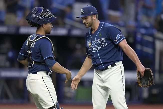 Tampa Bay Rays relief pitcher Colin Poche, right, celebrates with catcher Francisco Mejia after closing out the Miami Marlins during a baseball game Wednesday, May 25, 2022, in St. Petersburg, Fla. (AP Photo/Chris O'Meara)