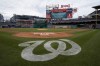 A message on the outfield screen announces the postponement of a baseball game between the Colorado Rockies and the Washington Nationals due to inclement weather, Friday, May 27, 2022, in Washington. The game was rescheduled for Saturday. (AP Photo/Patrick Semansky)
