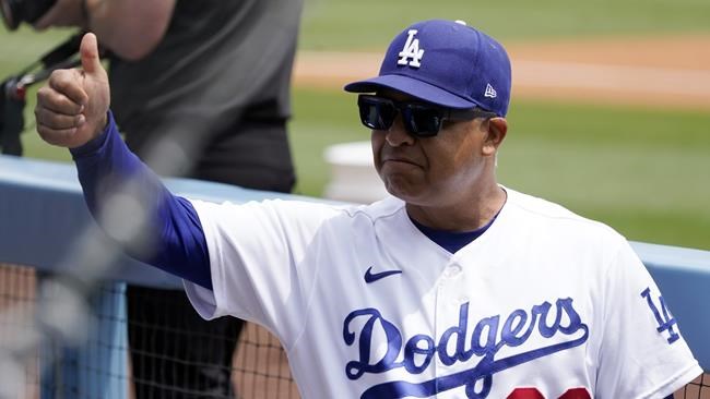 Los Angeles Dodgers manager Dave Roberts gives a thumbs up in the dugout during of the first game of a baseball double-header against the Arizona Diamondbacks Tuesday, May 17, 2022, in Los Angeles. (AP Photo/Marcio Jose Sanchez)