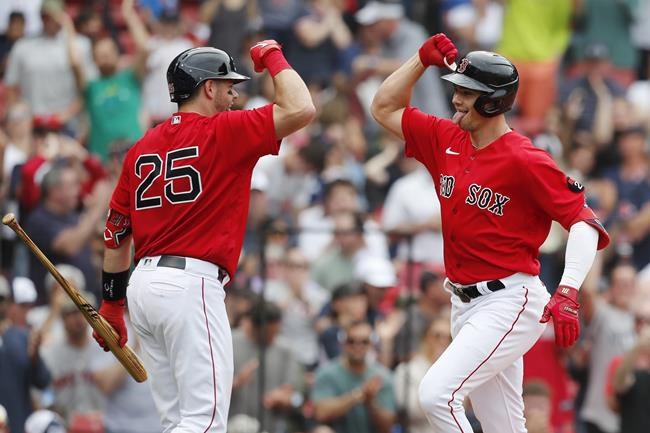 Boston Red Sox's Bobby Dalbec celebrates his solo home run with Kevin Plawecki (25) during the sixth inning of the first game of a baseball doubleheader against the Baltimore Orioles, Saturday, May 28, 2022, in Boston. (AP Photo/Michael Dwyer)