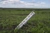 The remains of a cluster-type munition lie in a field in Cherkaska Lozova, outskirts of Kharkiv, eastern Ukraine, Saturday, May 28, 2022. Ukraine is one of the world's largest exporters of wheat, corn and sunflower oil, but the war and a Russian blockade of its ports have halted much of that flow, endangering world food supplies. Many of those ports are now also heavily mined. (AP Photo/Bernat Armangue)