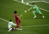 Real Madrid's goalkeeper Thibaut Courtois, right, makes a save in front of Liverpool's Mohamed Salah during the Champions League final soccer match between Liverpool and Real Madrid at the Stade de France in Saint Denis near Paris, Saturday, May 28, 2022. (AP Photo/Christophe Ena)