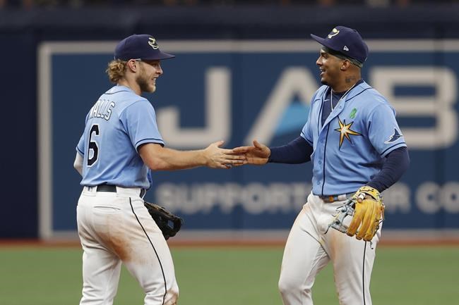 Tampa Bay Rays shortstop Taylor Walls, left, celebrates with teammate Wander Franco after defeating the New York Yankees in a baseball game Sunday, May 29, 2022, in St. Petersburg, Fla. (AP Photo/Scott Audette)