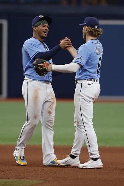 Tampa Bay Rays' Taylor Walls, right, celebrates with teammate Wander Franco after defeating the New York Yankees in a baseball game Sunday, May 29, 2022, in St. Petersburg, Fla. (AP Photo/Scott Audette)