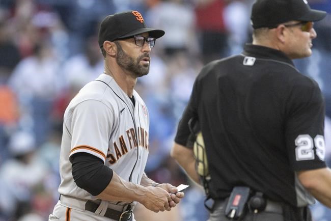 San Francisco Giants manager Gabe Kapler, left, approaches the mound during the ninth inning of a baseball game against the Philadelphia Phillies, Monday, May 30, 2022, in Philadelphia. (AP Photo/Laurence Kesterson)