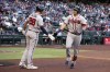 Atlanta Braves' Austin Riley, right, celebrates with Matt Olson (28) after hitting a solo home run against the Arizona Diamondbacks in the fourth inning during a baseball game, Monday, May 30, 2022, in Phoenix. (AP Photo/Rick Scuteri)